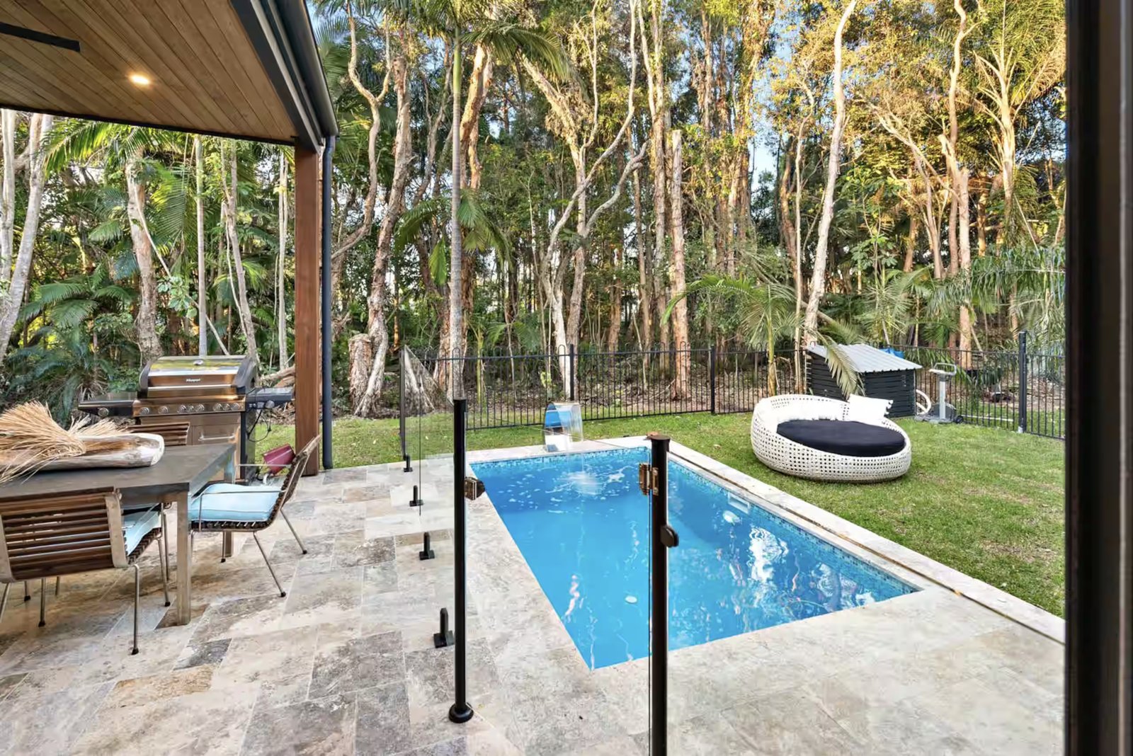 Vibrant, sunlit tropical rainforest canopy surrounding Retreat at Byron's private plunge pool